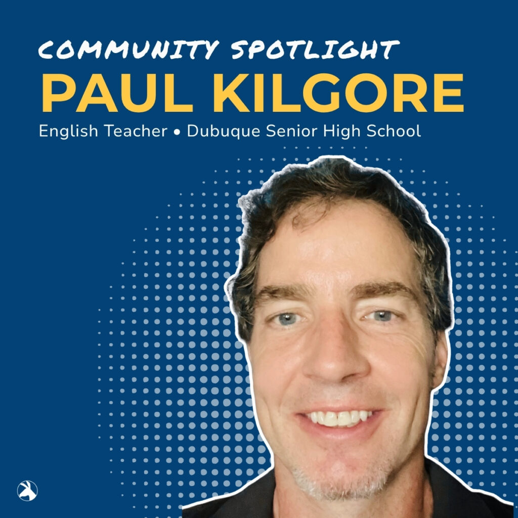 Community Spotlight: Paul Kilgore, English Teacher at Dubuque Senior High School. A close-up portrait of Paul Kilgore smiling, with a blue background featuring a dotted pattern.